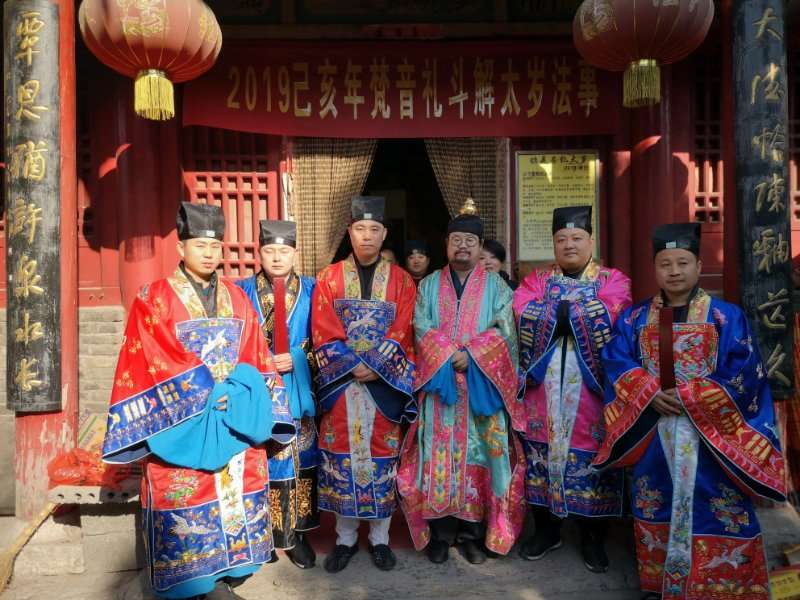Master Gu holding an official Taoist priest certification from the Zhengyi sect.